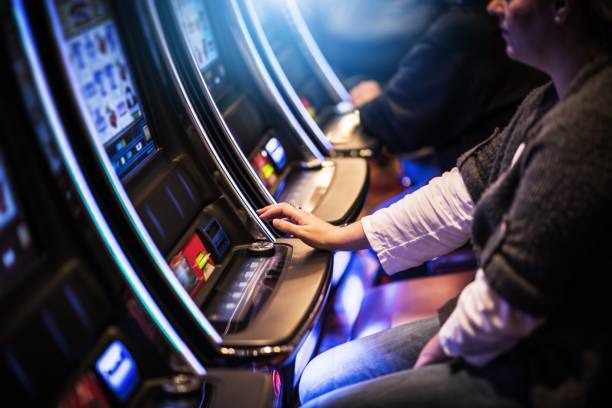 Live casino dealer at blackjack table with multiple camera angles